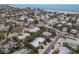 Aerial view of a beachfront home, highlighting its proximity to the ocean and neighborhood at 205 82Nd St # East, Holmes Beach, FL 34217