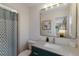 Clean bathroom with a dark green vanity and gold fixtures at 205 82Nd St # East, Holmes Beach, FL 34217