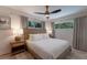 Serene bedroom with a king-size bed and a ceiling fan at 205 82Nd St # East, Holmes Beach, FL 34217