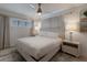 Bright bedroom with a comfortable bed and stylish lamps at 205 82Nd St # East, Holmes Beach, FL 34217