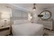 Bright bedroom with a comfortable bed and stylish lamps at 205 82Nd St # East, Holmes Beach, FL 34217