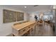Open concept dining area with wood table and seating, adjacent to kitchen and living room at 205 82Nd St # East, Holmes Beach, FL 34217