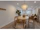 Bright dining room with round table, four chairs, and shell chandelier at 205 82Nd St # East, Holmes Beach, FL 34217