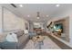 Open living room with L-shaped sofa, dining area, and hardwood floors at 205 82Nd St # East, Holmes Beach, FL 34217