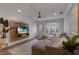 Bright living room with L-shaped sofa, mounted TV, and wood coffee table at 205 82Nd St # East, Holmes Beach, FL 34217