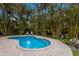 Relaxing kidney-shaped pool surrounded by lush landscaping at 205 82Nd St # East, Holmes Beach, FL 34217