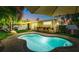 Evening view of a kidney-shaped pool with string lights at 205 82Nd St # East, Holmes Beach, FL 34217
