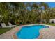 Peaceful kidney-shaped pool with patio and lounge chairs at 205 82Nd St # East, Holmes Beach, FL 34217