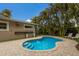 Charming pool area with stone patio and tropical plants at 205 82Nd St # East, Holmes Beach, FL 34217