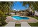 Inviting kidney-shaped pool with patio and lounge chairs at 205 82Nd St # East, Holmes Beach, FL 34217