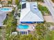 Aerial view of a blue house, pool, and lush landscaping at 215 75Th St, Holmes Beach, FL 34217