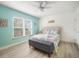 Beach-themed bedroom with a queen bed and sliding glass door access at 215 75Th St, Holmes Beach, FL 34217