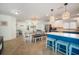 Bright dining area with kitchen island and seating, adjacent to living space at 215 75Th St, Holmes Beach, FL 34217