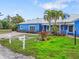 Charming blue house with a spacious lawn and walkway at 215 75Th St, Holmes Beach, FL 34217