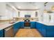 Modern kitchen with blue cabinets, stainless steel appliances at 215 75Th St, Holmes Beach, FL 34217