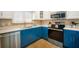 L-shaped kitchen with stainless steel appliances and white cabinets at 215 75Th St, Holmes Beach, FL 34217