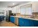 Kitchen features stainless steel appliances and blue cabinets at 215 75Th St, Holmes Beach, FL 34217