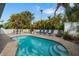 Relaxing kidney-shaped pool with brick patio and lounge chairs at 215 75Th St, Holmes Beach, FL 34217