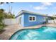 Blue house with a kidney-shaped pool and patio at 215 75Th St, Holmes Beach, FL 34217
