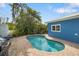 Relaxing kidney-shaped pool with brick patio and grill at 215 75Th St, Holmes Beach, FL 34217