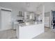 Modern kitchen with white cabinetry and large island at 21970 Cellini Ave, Port Charlotte, FL 33952