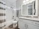 Clean bathroom with white cabinets, granite countertop, and a shower/tub combo at 2511 Prospect St, Sarasota, FL 34239