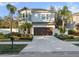 Two-story house with a brown garage door and nicely landscaped yard at 2511 Prospect St, Sarasota, FL 34239