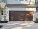 Two-car garage with brown door and driveway at 2511 Prospect St, Sarasota, FL 34239