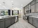 Open kitchen with island, stainless steel appliances, and gray cabinets at 2511 Prospect St, Sarasota, FL 34239