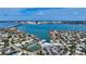 Stunning aerial view of a waterfront property with boat dock, tennis courts, and views of Sarasota Bay at 279 Robin Dr, Sarasota, FL 34236