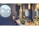 Stylish bathroom with a unique vessel sink, pendant lighting, and custom mirror detailing at 279 Robin Dr, Sarasota, FL 34236