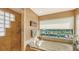 Elegant bathroom features soaking tub, large window with marina views, and tiled shower at 279 Robin Dr, Sarasota, FL 34236