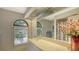 Well-lit bathroom featuring a large mirror, arched window, and neutral-toned decor at 279 Robin Dr, Sarasota, FL 34236