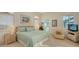 Bright bedroom featuring shuttered windows, a comfortable bed, and access to ensuite bathroom at 279 Robin Dr, Sarasota, FL 34236