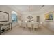 Elegant dining room with chandelier lighting, a large table, and bright, neutral decor at 279 Robin Dr, Sarasota, FL 34236