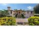 Grand two-story home with a lush, landscaped front yard and circular driveway leading to the entrance at 279 Robin Dr, Sarasota, FL 34236