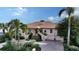 Beautiful two-story waterfront property with manicured landscaping, grand entrance, and tile roof at 279 Robin Dr, Sarasota, FL 34236