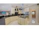 Modern kitchen boasts stainless steel appliances, black countertops, and a functional center island at 279 Robin Dr, Sarasota, FL 34236