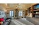 Comfortable living room with wood ceiling, built-in shelves, and a large display cabinet at 279 Robin Dr, Sarasota, FL 34236