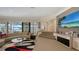 Bright living room with waterfront view, neutral decor, and adjacent staircase leading to other rooms at 279 Robin Dr, Sarasota, FL 34236
