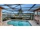 Screened-in pool area with in-ground pool, and expansive harbor views beyond at 279 Robin Dr, Sarasota, FL 34236