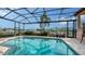 Screened-in pool and deck overlooking harbor in this waterfront property at 279 Robin Dr, Sarasota, FL 34236