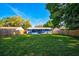 Large backyard with grassy lawn and a newly painted house at 3110 Elmer St, Sarasota, FL 34231