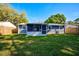Large backyard with grassy lawn and a newly painted house at 3110 Elmer St, Sarasota, FL 34231