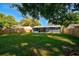 Large backyard with grassy lawn and a newly painted house at 3110 Elmer St, Sarasota, FL 34231