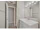 Updated bathroom with single vanity, new flooring, and a large mirror at 3110 Elmer St, Sarasota, FL 34231