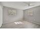 Bedroom with two windows, ceiling fan and wood-look floors at 3110 Elmer St, Sarasota, FL 34231