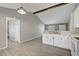 Bright kitchen features white cabinets, new flooring, and a breakfast bar at 3110 Elmer St, Sarasota, FL 34231