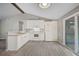 Modern kitchen with white cabinets, gray walls, and tile floors at 3110 Elmer St, Sarasota, FL 34231