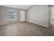 Living room with gray walls, wood-look tile floors, and vaulted ceiling at 3110 Elmer St, Sarasota, FL 34231